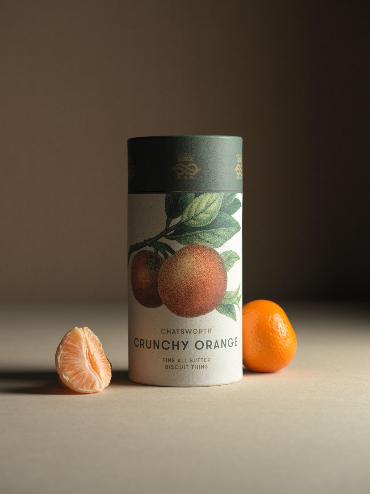 Orange Chatsworth Artisan Biscuits. Vertical packaging with botanical illustrations across the side.