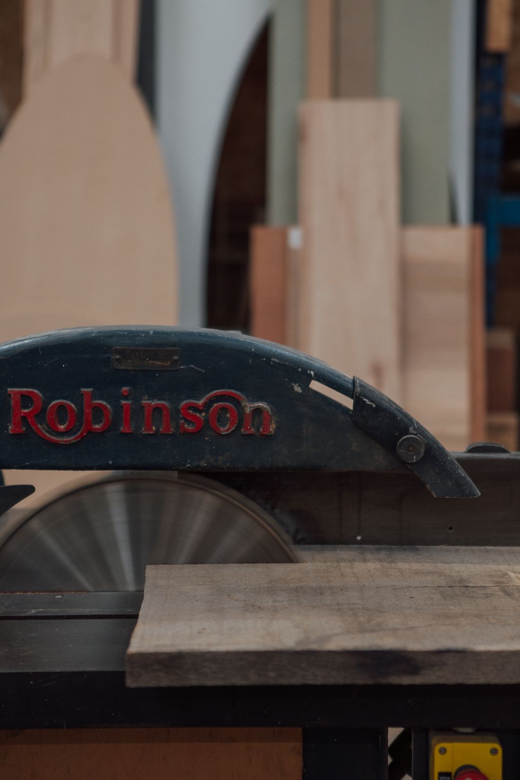 Close up of a Robinson circular saw cutting through reclaimed plank of wood in 93 Makes workshop