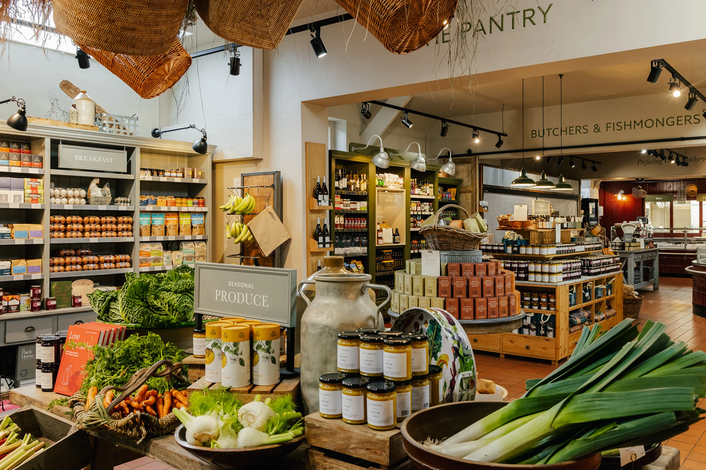 Wide-angle interior of farmshop shelves and central islands