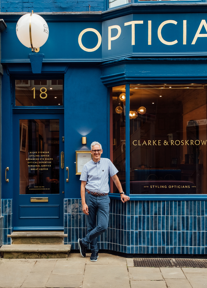 The owner of the business proudly standing outside Clarke & Roskrow.