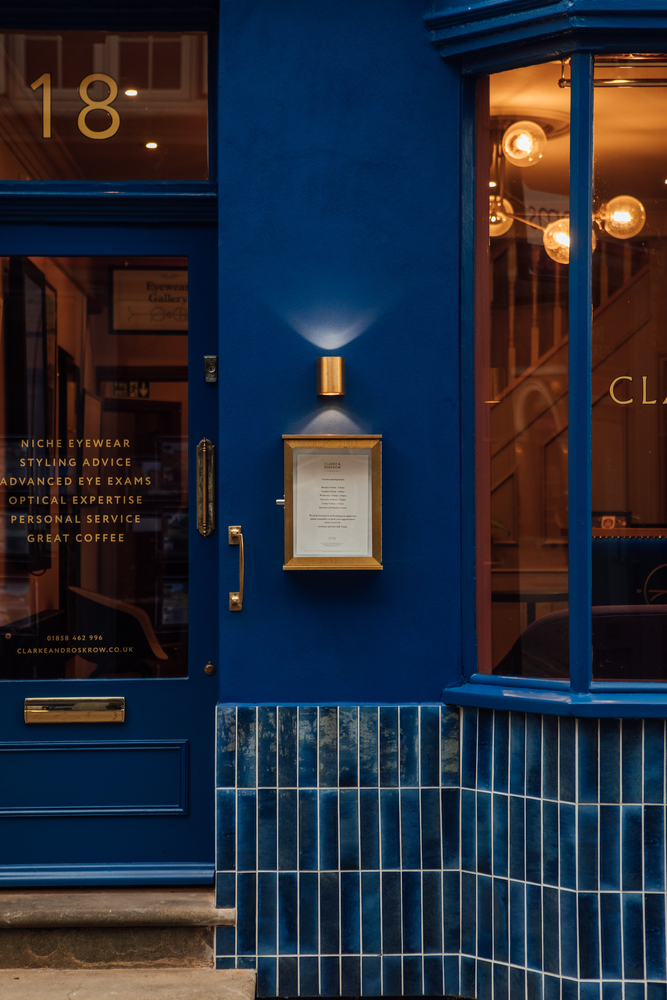 View of Clarke & Roskrow’s shop front. Brass details on the cobalt blue rendered walls.