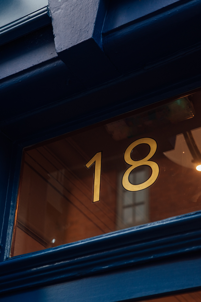 A close up of Clarke & Roskrow’s door number 18 painted and gilded with gold leaf.