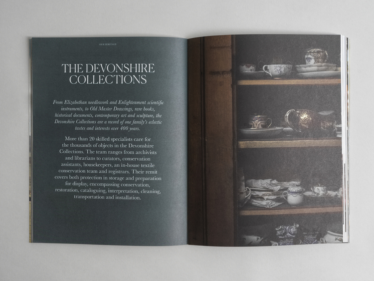 Looking inside the Chatsworth House Trust Annual Review. THE DEVONSHIRE COLLECTIONS. Traditional ceramics inside a wooden cupboard.
