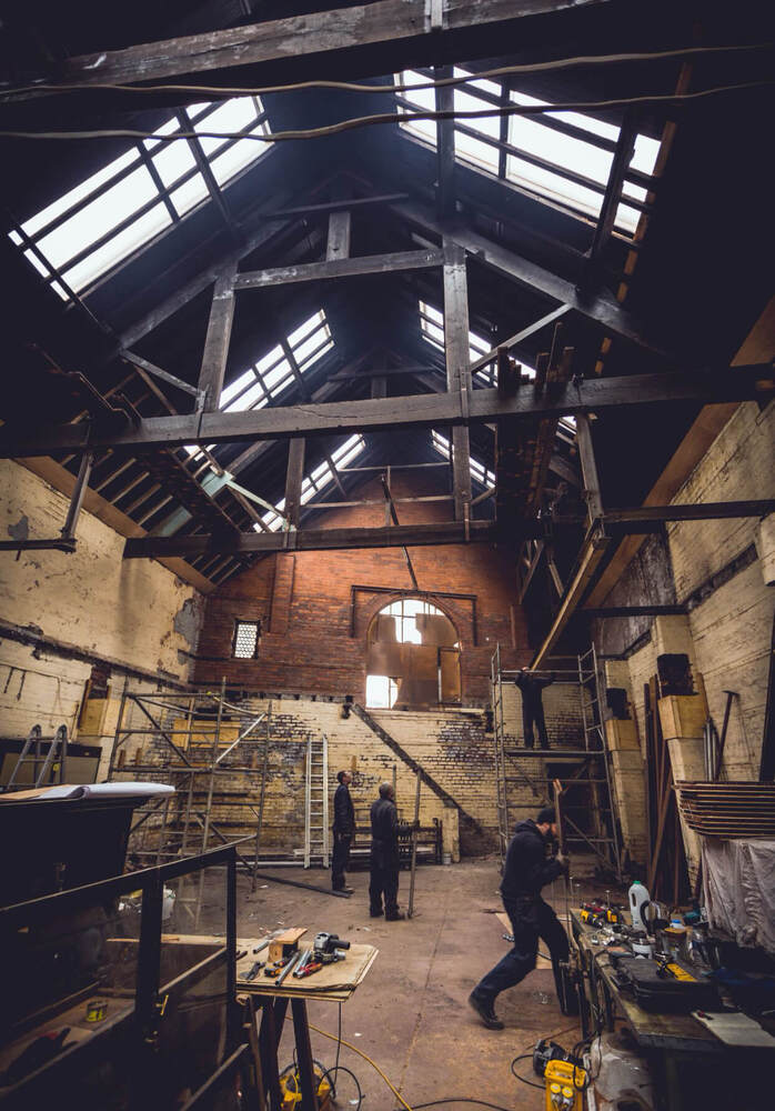 The Mowbray venue in Sheffield during renovation of the former industrial building with exposed wood beams & scaffolding. 