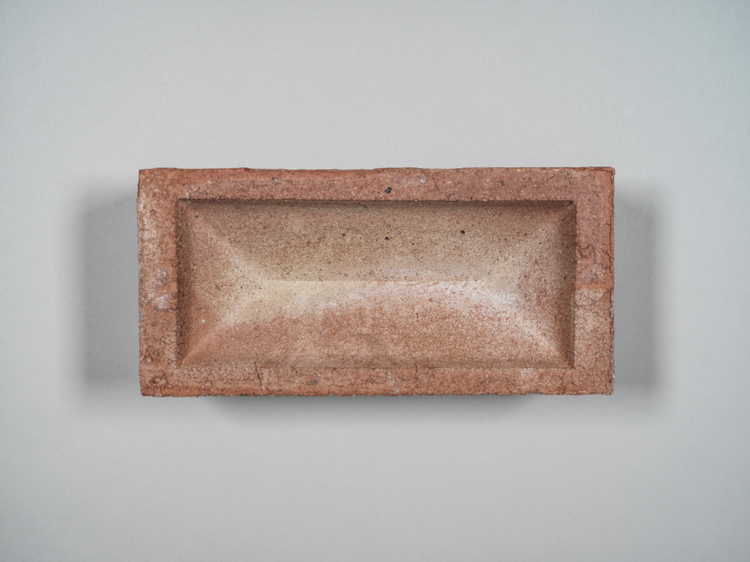 Sample reclaimed brick angular indent in a soft pale pink colour with white flecks. 